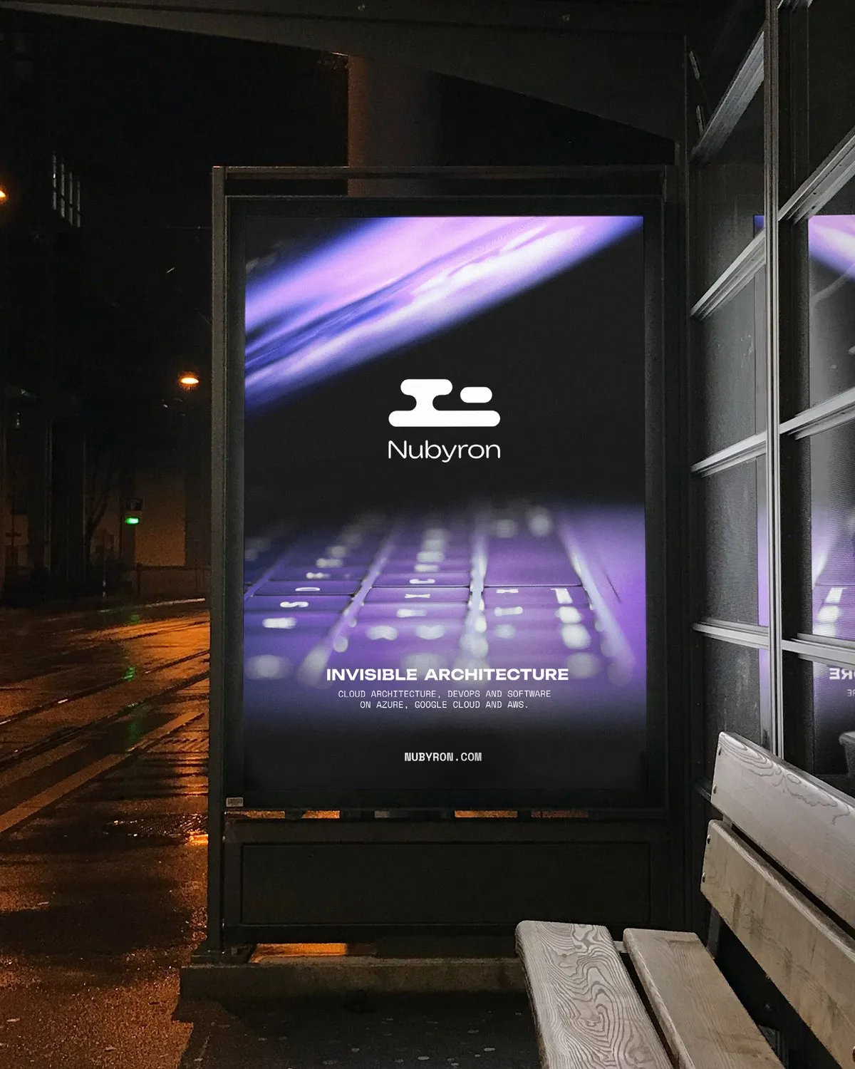 Close-up of a Nubyron bus-shelter poster at night