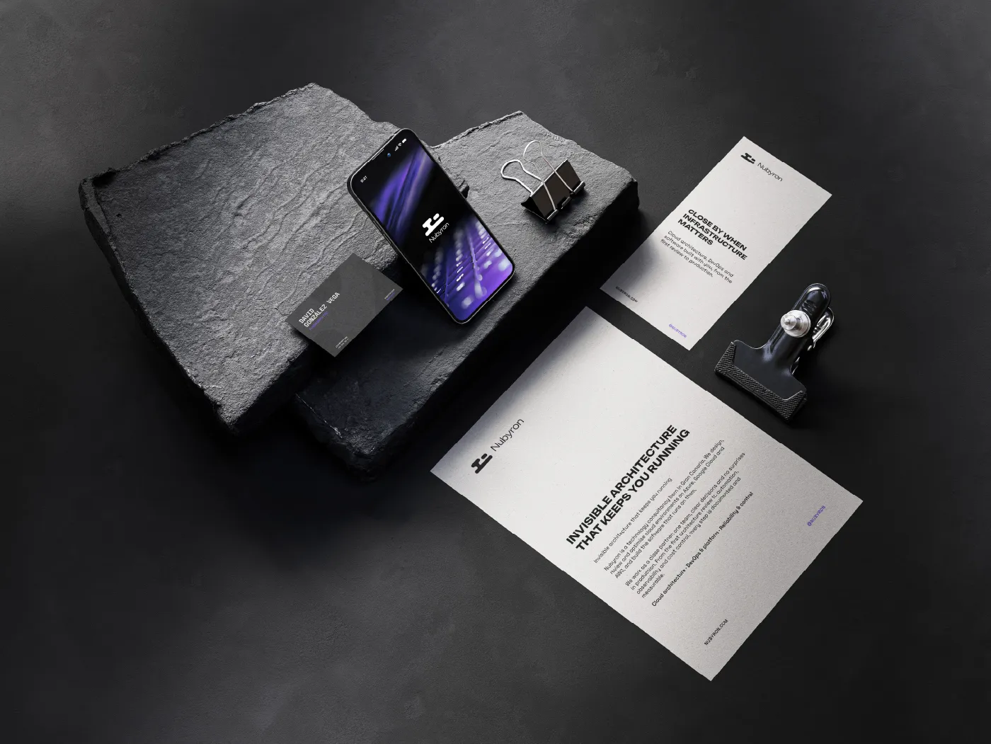 Nubyron stationery and a phone on a dark stone surface
